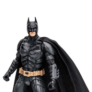 mcfarlane-dc-multiverse-the-dark-knight-batman-vault-edition-figure or collectible statue shown against a plain white background. The figure is dressed in a predominantly black armored suit with a black cape and a metallic gold utility belt.